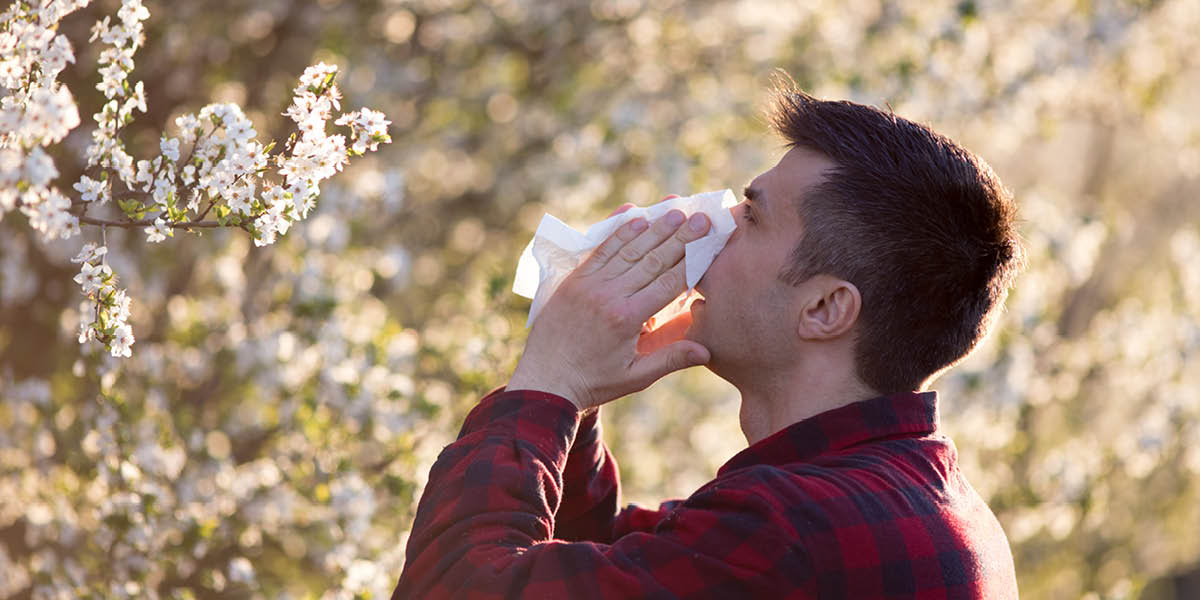 Allergies - A man sneezing