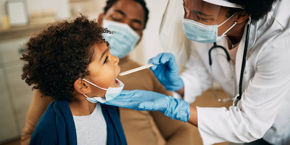 Pediatrics - A doctor examining a young boy