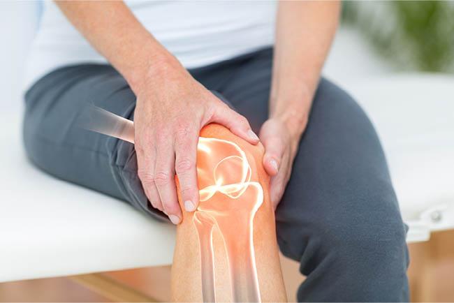 Bones, Muscles, and Joints - A woman holding her knee